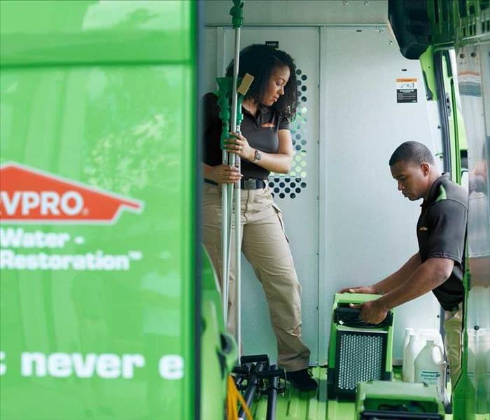 tech arriving at a job site in SERVPRO truck